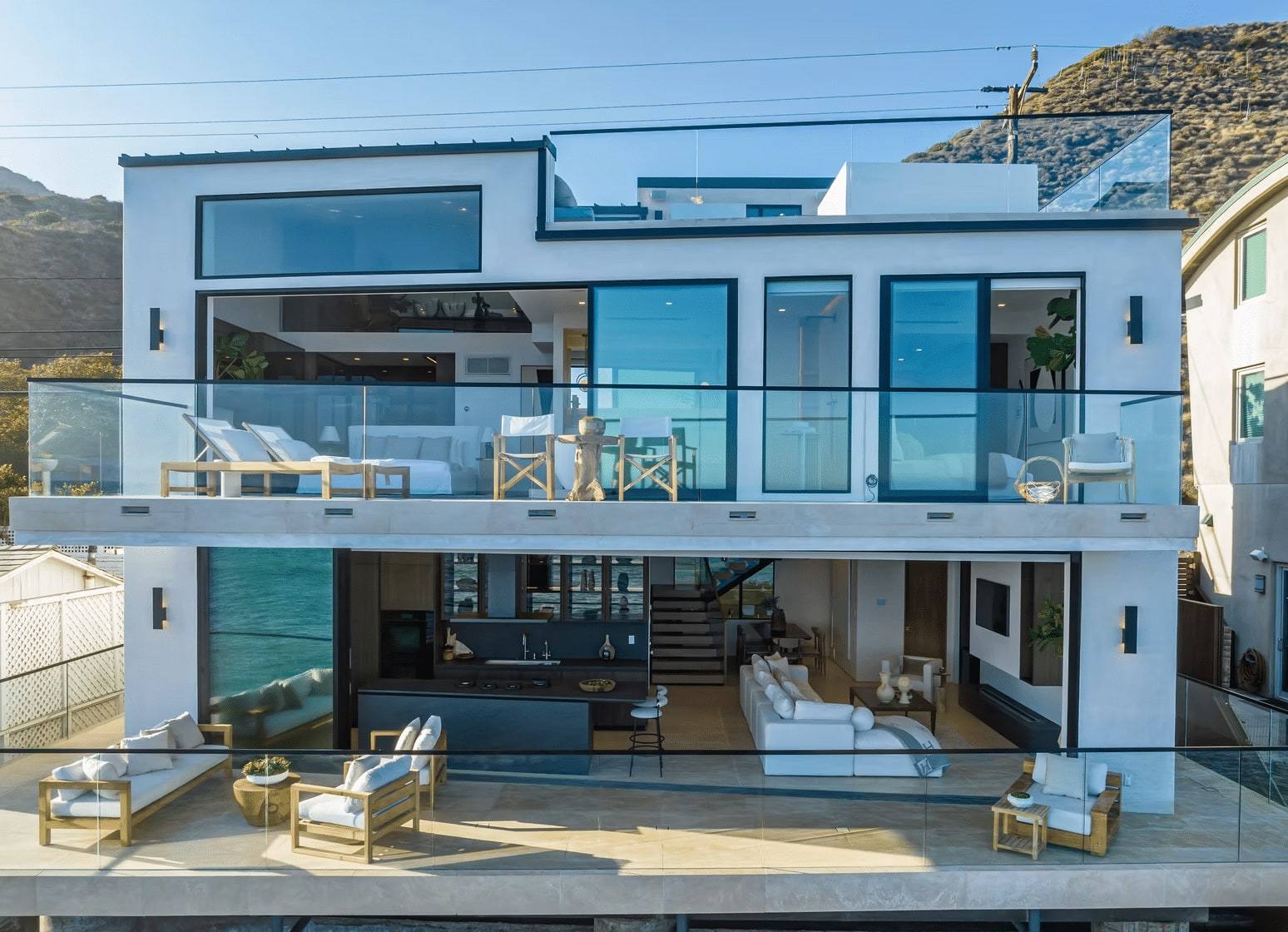 Ocean side of the Malibu Road residence, two floors of glass with terraces